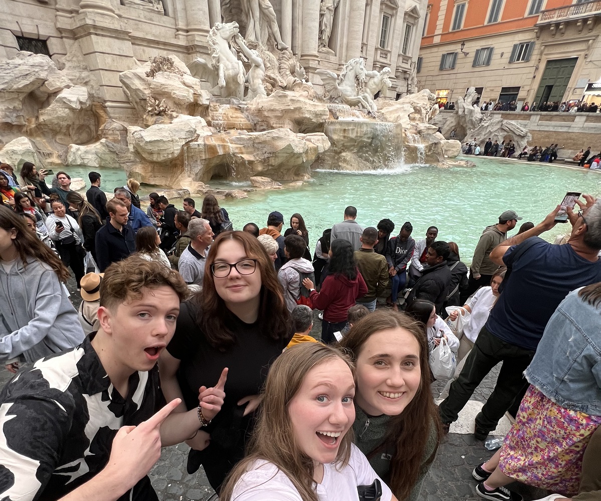 students in front of fountain