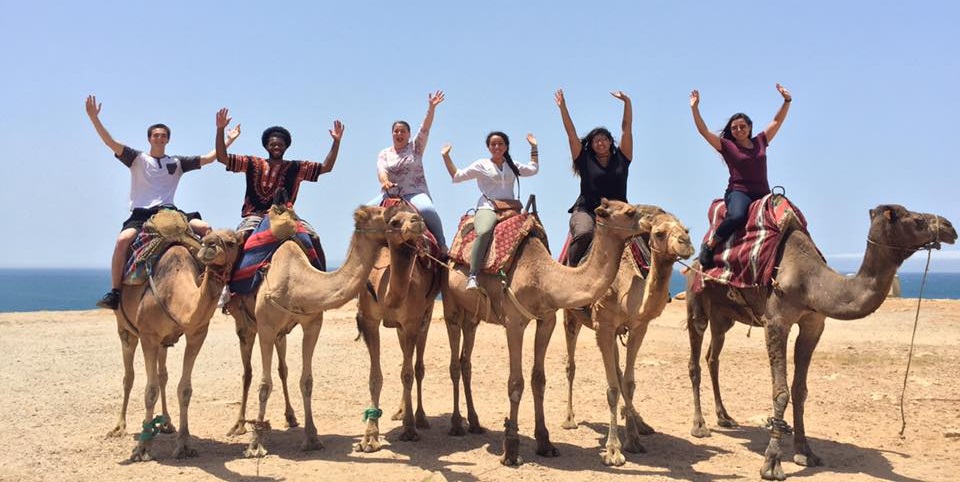 students on camels on first gen abroad trip
